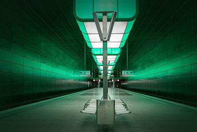 Illuminated subway station platform at airport