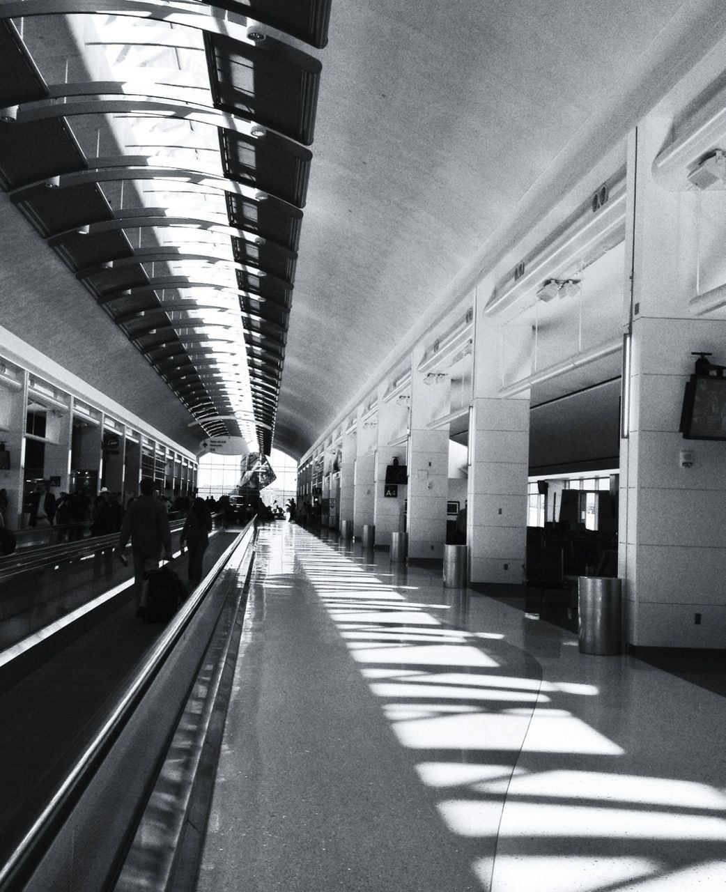 architecture, built structure, transportation, indoors, the way forward, diminishing perspective, ceiling, incidental people, public transportation, railroad station platform, railroad station, vanishing point, rail transportation, travel, architectural column, city life, city, railroad track, empty, building exterior