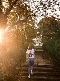 Full length of woman walking on staircase at park