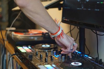 Cropped hand of man mixing music at recording studio