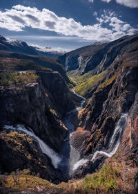 Scenic view of waterfall against sky