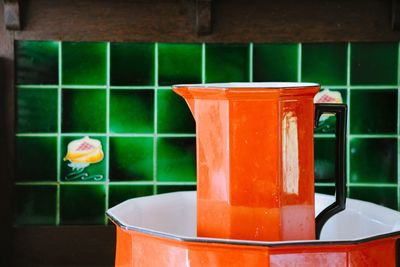 Close-up of orange containers on table