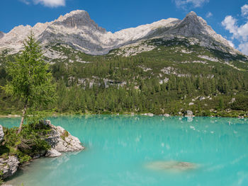 Scenic view of lake and mountains against sky