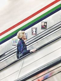 Full length of woman standing by railing