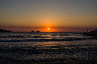 Scenic view of sea against orange sky