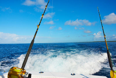 Sailboat in sea against blue sky