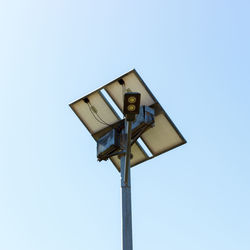 Low angle view of lighting equipment against clear sky