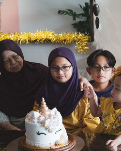 Happy asian family celebrating birthday together at home.