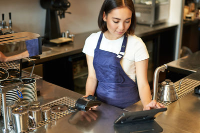 Portrait of young woman working in cafe