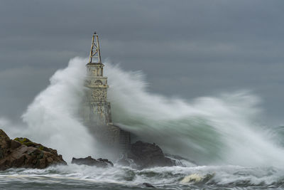 View of lighthouse against cloudy sky