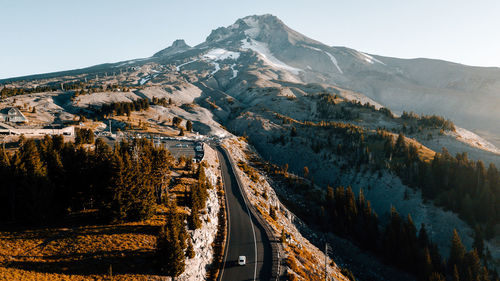Aerial view of snowcapped mountains against clear sky