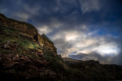 Low angle view of rock formation against sky