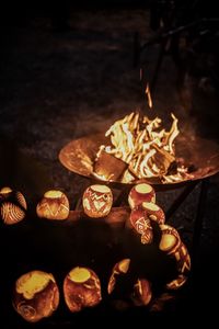 Close-up of burning candles on wooden wall