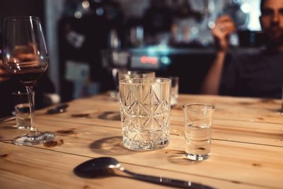 Close-up of wine glasses on table