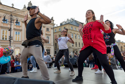 Group of people in city against sky