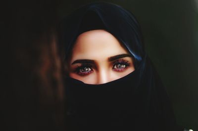 Close-up portrait of young woman wearing burkha