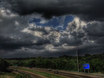 Road passing through storm clouds