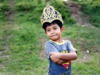 Smiling boy wearing crown looking away