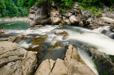 Scenic view of river flowing through rocks