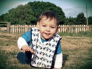 Portrait of smiling boy on field