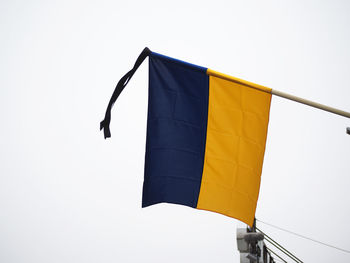 Low angle view of flag against clear sky