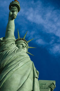 Low angle view of statue against blue sky