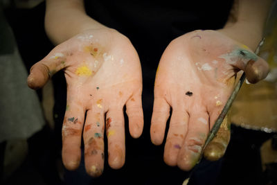 Midsection of person holding paintbrush