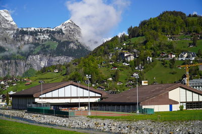 Scenic view of building and mountains against sky