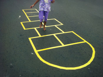 Girl playing hop scotch
