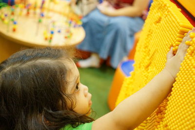 Close-up of girl with women in background