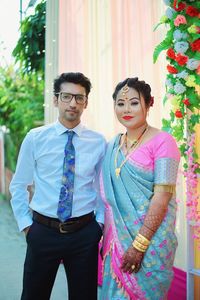 Portrait of smiling couple standing against sky