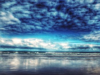 Scenic view of sea against cloudy sky