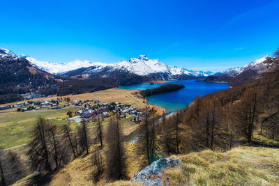 Scenic view of snowcapped mountains against blue sky