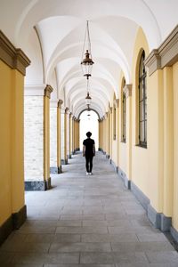 Rear view of man walking in corridor