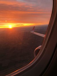 Aerial view of sunset seen through airplane window