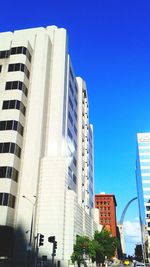 Low angle view of buildings against clear blue sky