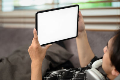 Midsection of man using digital tablet