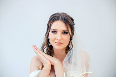 Portrait of a beautiful young woman over white background