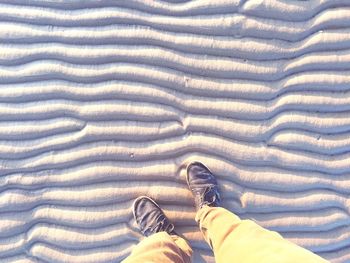Low section of woman standing on tiled floor
