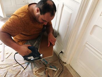 High angle view of man photographing at home