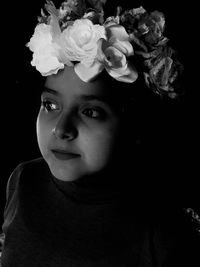 Portrait of beautiful woman against black background