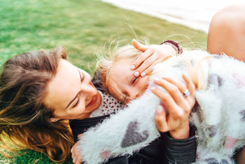 MIDSECTION OF MOTHER AND DAUGHTER ON BABY