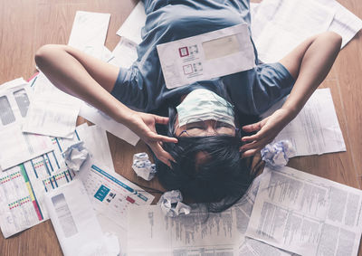 High angle view of woman sitting on floor at home