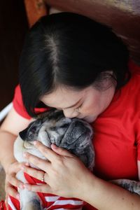 Affectionate woman with dog at home