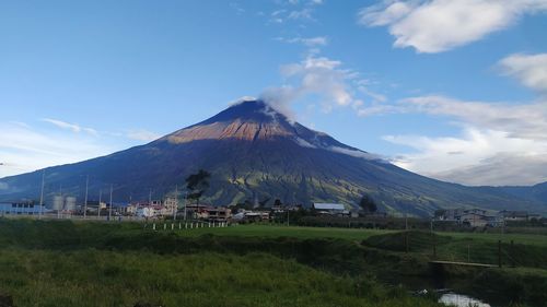 Scenic view of land and mountains against sky