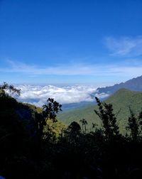 Scenic view of mountains against blue sky