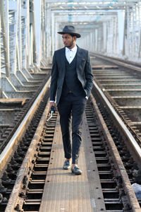 Portrait of man standing on railroad track