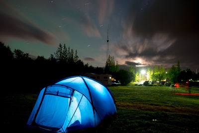 Tent on field against sky at night