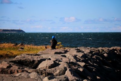 Rear view of man standing on beach