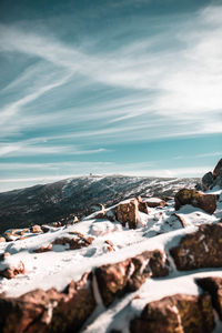 Snow covered land against sky